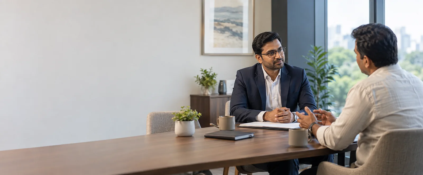 Indian business owner in a confidential consultation with a professional adviser